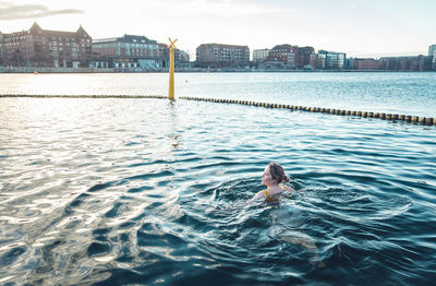 Portrait of woman swimming in pool