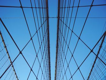 Low angle view of power lines against blue sky