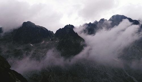 Scenic view of mountains against cloudy sky