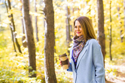 Portrait of a smiling young woman in forest