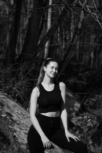 Portrait of woman sitting in a forest