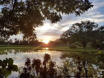 Scenic view of lake against sky during sunset