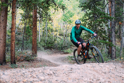 Man riding bicycle in forest