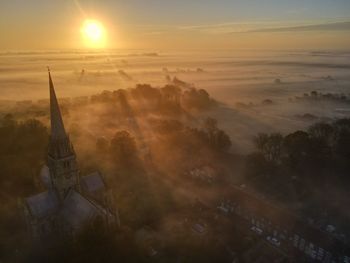 Aerial view of building against sky during sunset