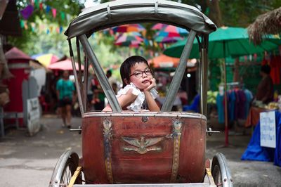 Portrait of girl sitting in pedicab