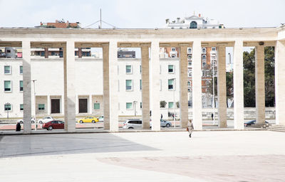 Building by street in city against sky