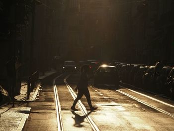 Side view of woman crossing street