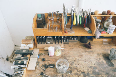 Overhead shot of wooden workbench with assorted tools and materials