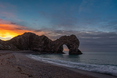 Durdle door view from the beach at sunrise 