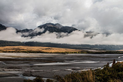 Scenic view of lake and mountains against sky