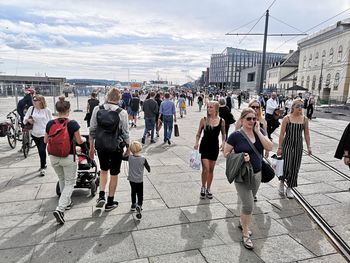 Group of people walking on street in city