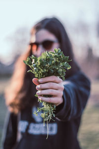 Close-up of woman holding plants