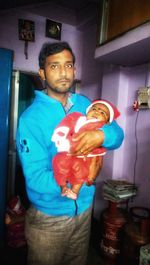 Portrait of young man standing at home