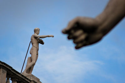 Low angle view of statue against blue sky