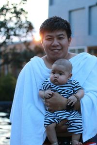 Portrait of father holding baby