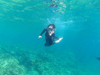 Woman jumping in sea