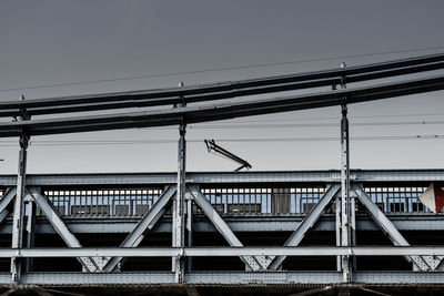 Low angle view of train on railway bridge against clear sky