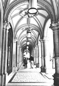 People walking in corridor of building