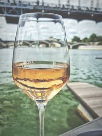 Close-up of wineglass by river