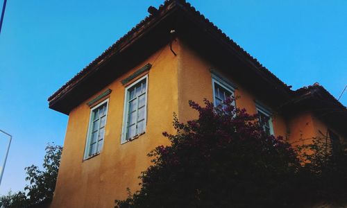 Low angle view of building against clear blue sky