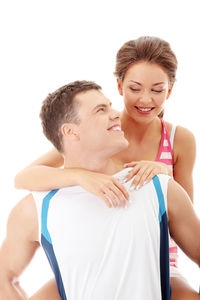 Happy friends looking away against white background