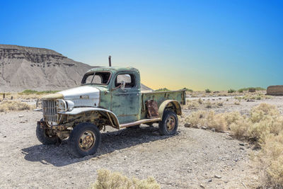 Truck on field against clear sky