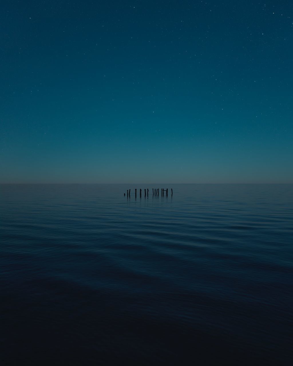 sky, water, beauty in nature, tranquil scene, horizon over water, scenics - nature, waterfront, horizon, tranquility, sea, nature, blue, no people, idyllic, reflection, astronomy, space, long exposure, night