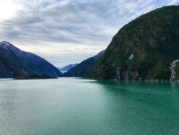 Scenic view of lake and mountains against sky