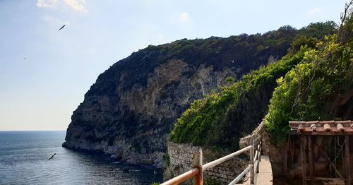 Scenic view of sea and mountains against sky