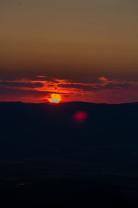 Scenic view of dramatic sky during sunset