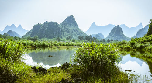 Scenic view of lake and mountains against sky