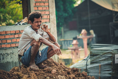 Young man sitting outdoors