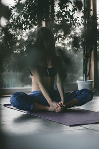 Young woman doing yoga at home