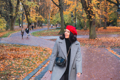 Portrait of woman walking on road