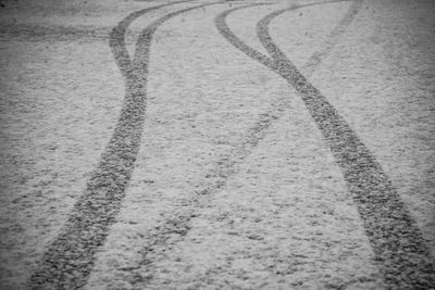 High angle view of tire tracks on road
