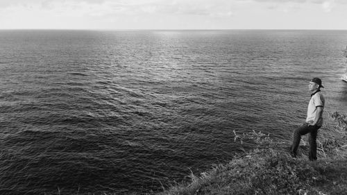 People standing on sea against sky