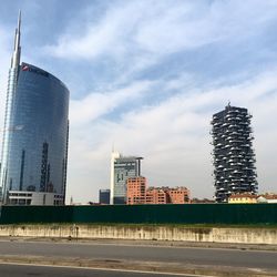 Buildings against cloudy sky