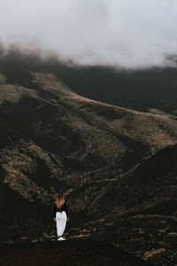 Rear view of woman standing on land