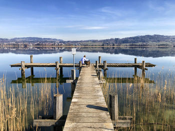 Relaxing on a pier at the lake of pfäffikon 