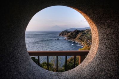 Scenic view of sea against sky seen through arch