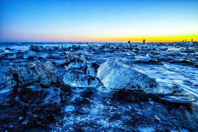 Scenic view of sea against clear sky at sunset