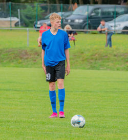 Full length of boy playing ball on field