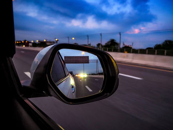 View of car on side-view mirror