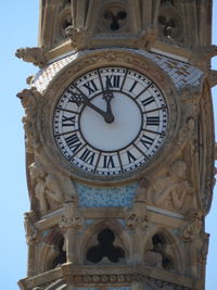 Low angle view of clock tower against sky