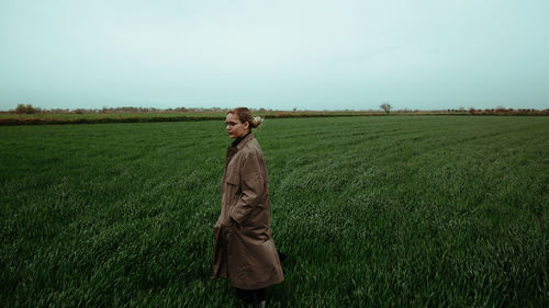 Man standing on field against sky