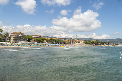 Scenic view of sea and buildings against sky