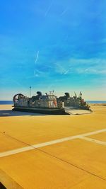 Ship by sea against blue sky on sunny day