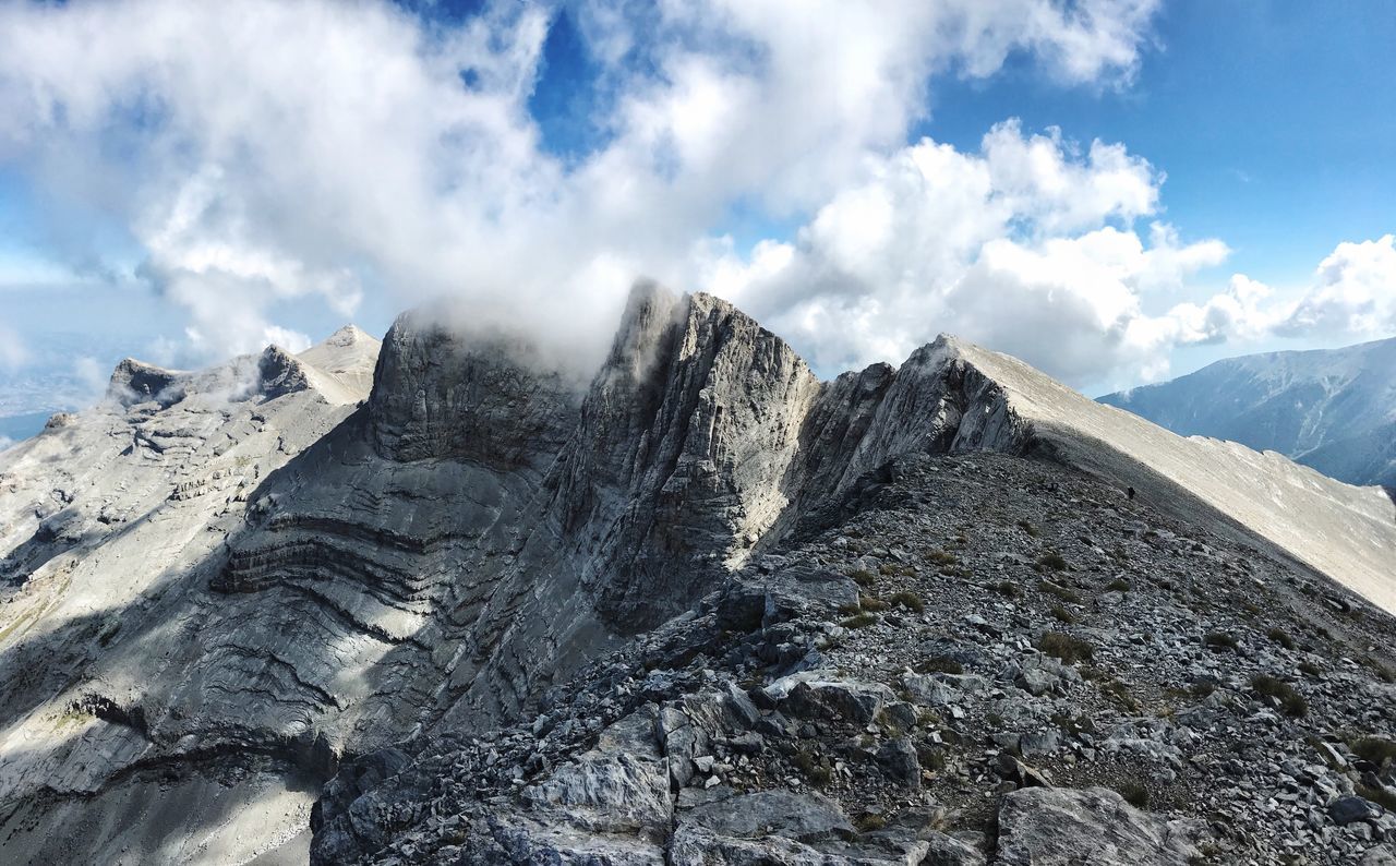 mountain, cloud - sky, sky, scenics - nature, beauty in nature, environment, tranquil scene, landscape, tranquility, nature, non-urban scene, mountain range, snow, day, rock, no people, remote, winter, idyllic, outdoors, mountain peak, formation, snowcapped mountain