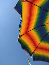 Low angle view of multi colored flag against clear sky