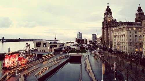 High angle view of buildings against cloudy sky